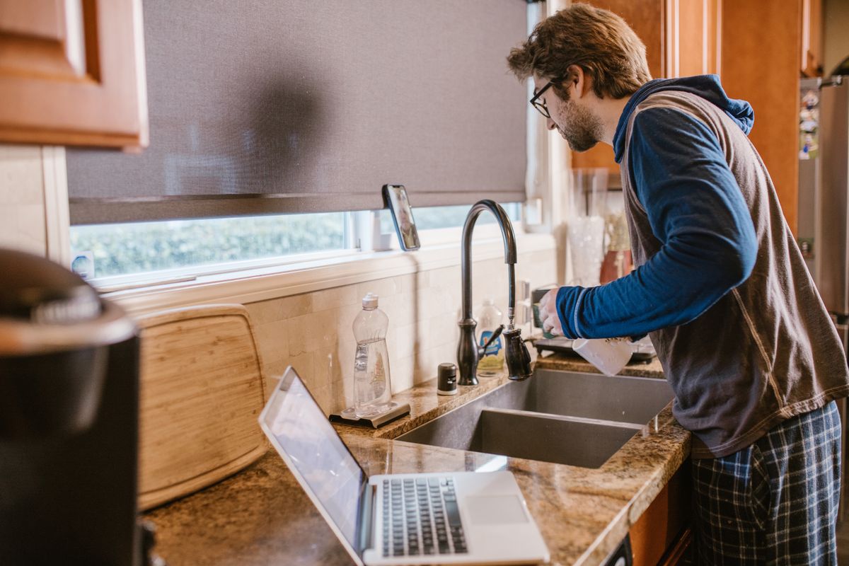 Handyman performing a repair service in a modern kitchen