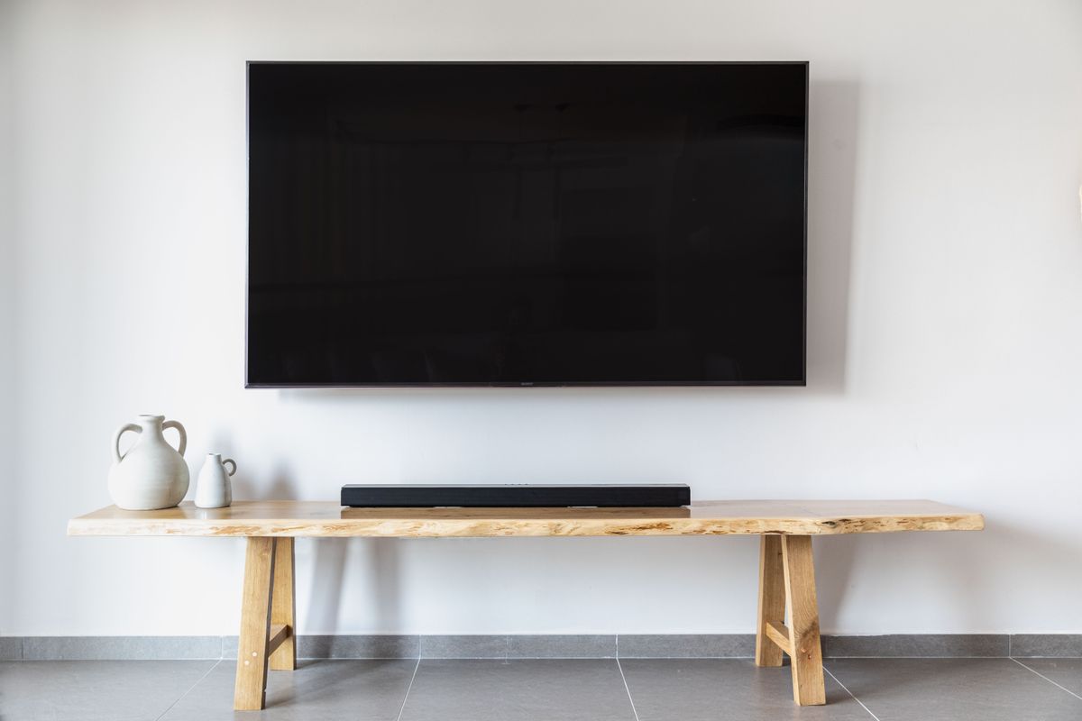 Flat screen television mounted on wall in a contemporary living room with modern interior design