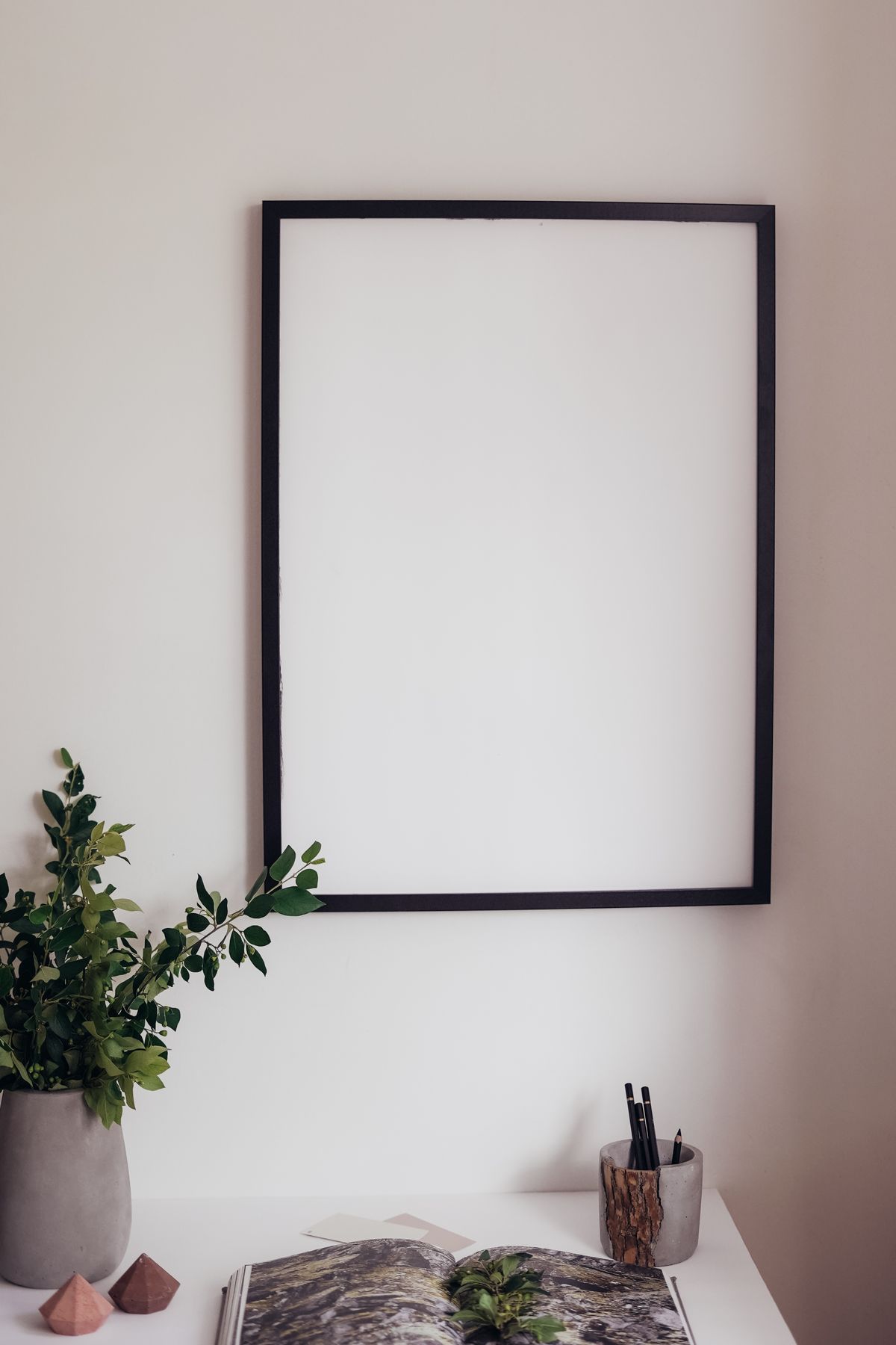 Blank picture frame on a wall, clean interior background
